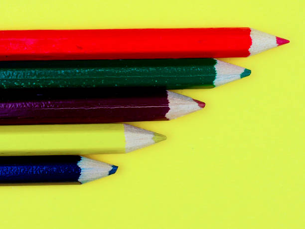 istock colored pencils on a yellow background, space for text 1000759154