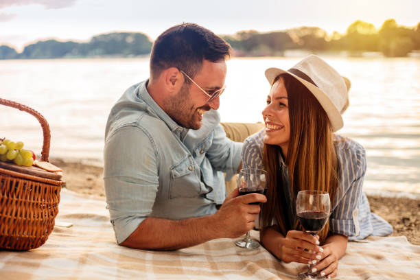 istock Happy young couple enjoying a picnic by the river 1000759624