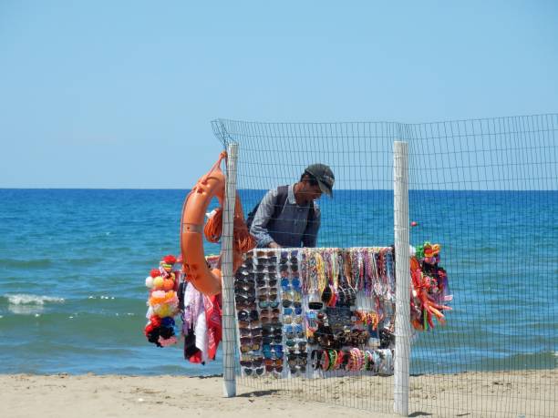 Capaccio, Salerno, Campania, Italy - June 29, 2018: Street vendor along the beach beyond the lido enclosure