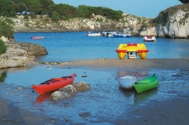 Canoes and pedal boats at the Porto Badisco bay, Salento, Apulia, Italy