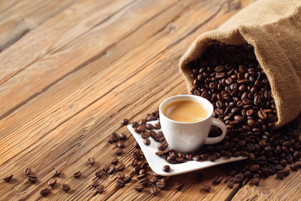 istock Coffee cup espresso with coffee beans and wooden background 1000768136