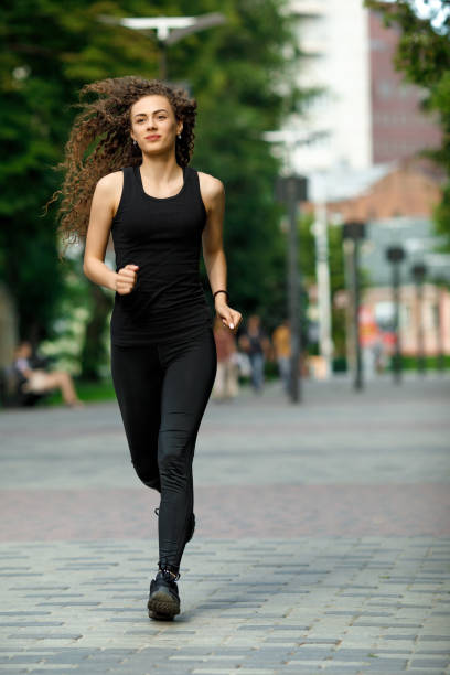 istock young attractive woman running 1000777502