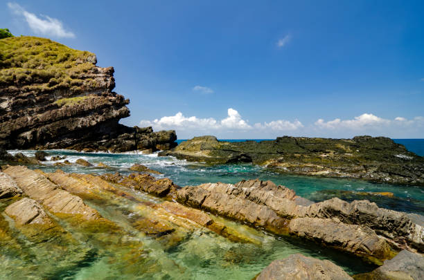 istock unique rocks formation and texture surrounded by clear water at sunny day 1000777816