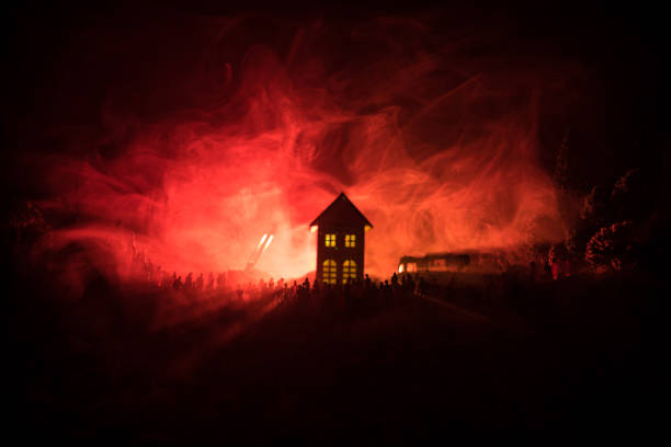 istock Huge Flame Distracting House on Fire. Fire engine with ladder and fireman trying to save house. Fireman at work. Fire Safety Concept. 1000794332