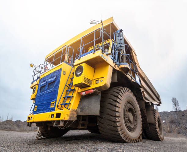 istock Tip truck stand in open pit quarry, close up 1000794672