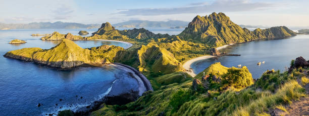 Panoramic warm view at top of 'Padar Island' in sunrise (late morning) from Komodo Island, Komodo National Park, Labuan Bajo, Flores, Indonesia. in summer Panoramic warm view at top of 'Padar Island' in sunrise (late morning) from Komodo Island, Komodo National Park, Labuan Bajo, Flores, Indonesia. in summer pulau komodo stock pictures, royalty-free photos & images