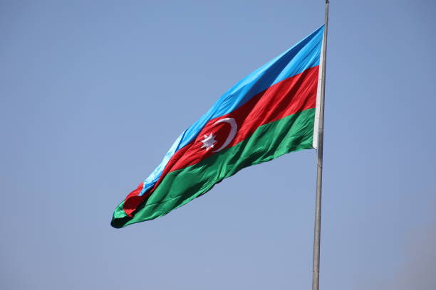 istock Azerbaijan national flag with Crescent moon. Flags waving wind 1000818526