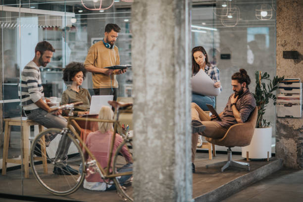 istock Young multi-tasking freelance workers working at casual office. 1000830724