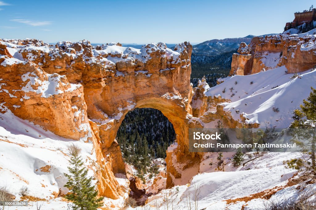 Nature Bridge Rock Formation at Bryce Canyon National Park With Snow In Winter, Utah, USA. Natural Bridge is One of Several Natural Arches in Bryce Canyon and Creates a Beautiful Scene at this viewpoint. Winter Stock Photo