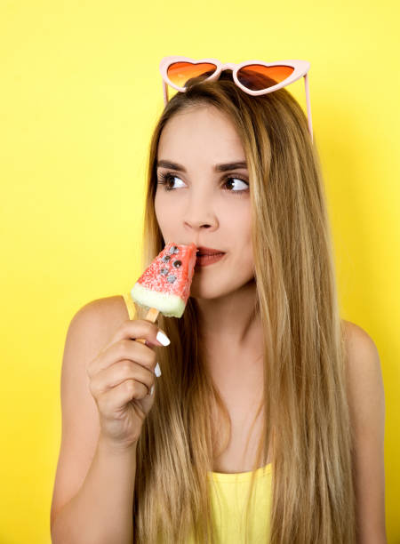 istock Young woman eating ice cream 1000841332