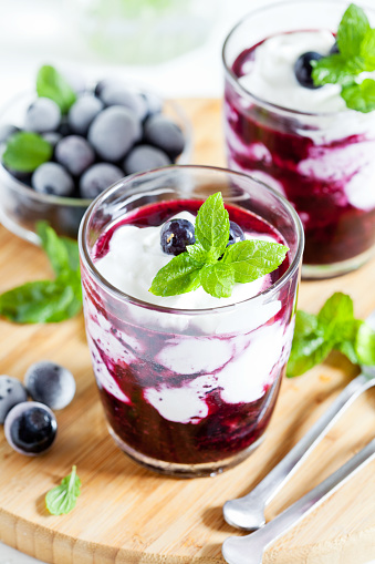 Glasses of homemade yogurt with organic blueberries