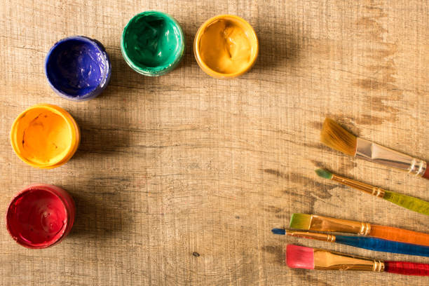 istock Various brushes and paints on the old wooden table . The view from the top. Creative concept 1000841834