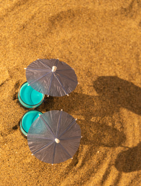 istock colorful shots drinks on a sandy beach with umbrellas for drinks 1000842140