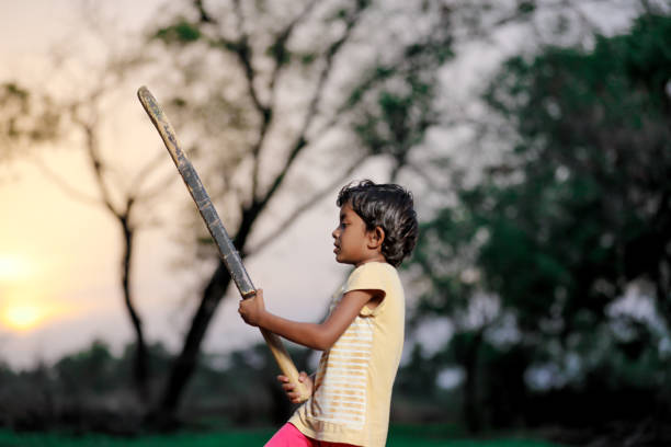 istock Indian girl child playing cricket 1000842862