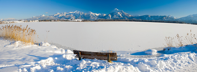 rural landscape with mountains and lake Hopfensee  in Bavaria at winter