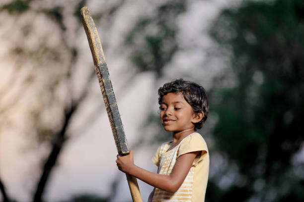 istock Indian girl child playing cricket 1000846446