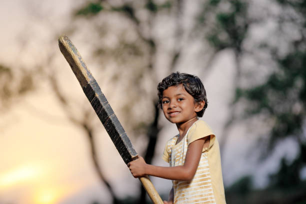istock Indian girl child playing cricket 1000847132