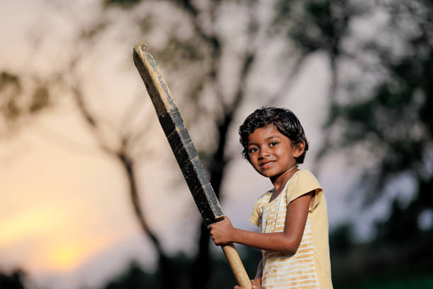 istock Indian girl child playing cricket 1000849332