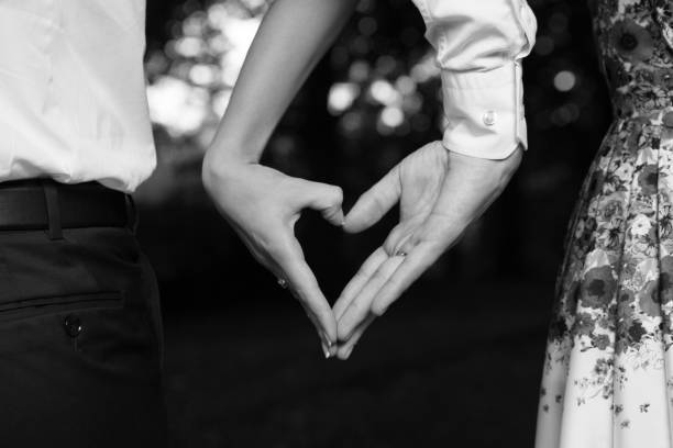 istock Bride and groom standing together with heart 1000849728
