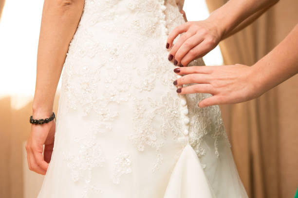 istock Helping the bride to put her wedding dress on. 1000849814