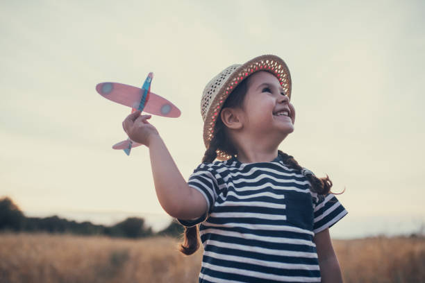 istock Cute smiling candid child with a toy airplane 1000853700