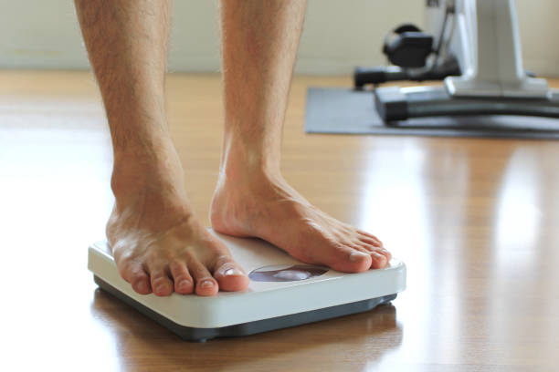 istock Male on the weight scale for check weight, Diet concept 1000854198