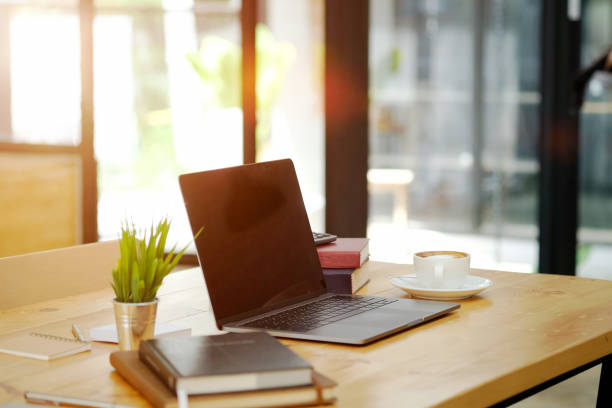 istock Mockup laptop comfortable work table and office supplies in office. 1000861522