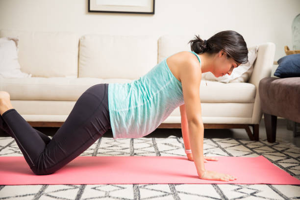 istock Woman Doing Press-Ups During Her Pregnancy On Exercise Mat 1000868380