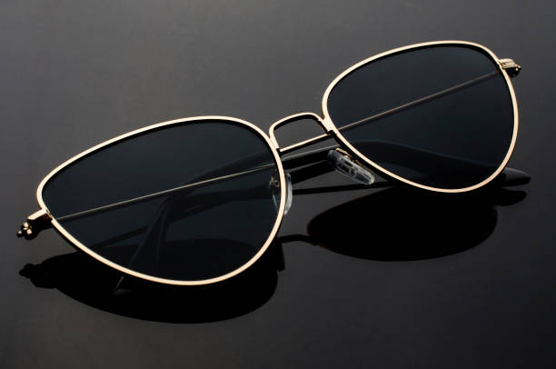 istock sunglasses cat's eye in metal frame isolated on black 1000880618
