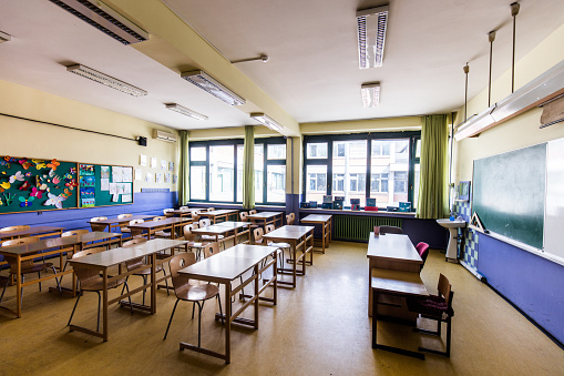 Empty classroom with chairs, desks.