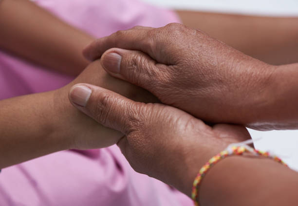 istock Elderly holding a young child hand 1000895934