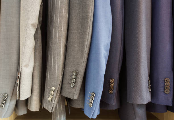 istock Row of men suit jackets on hangers 1000915390