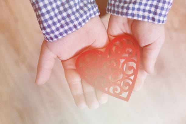 istock A child holding a heart valentine's day, valentine, light toning 1000915976