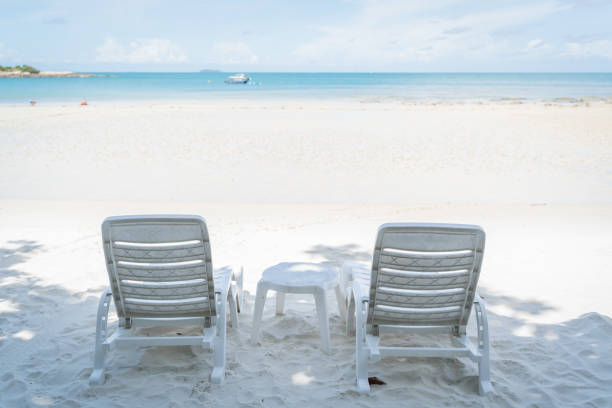istock empty beach chair over looking the clear blue sky and ocean 1000919220