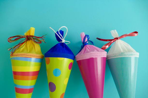 Four multi colored conical bag of sweets stock photo