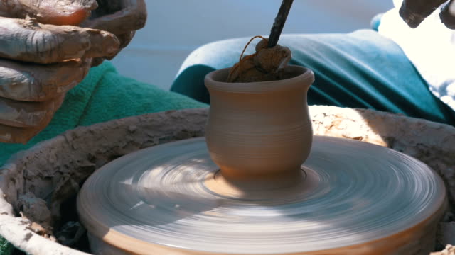 Potter's Hands Work with Clay on a Potter's Wheel