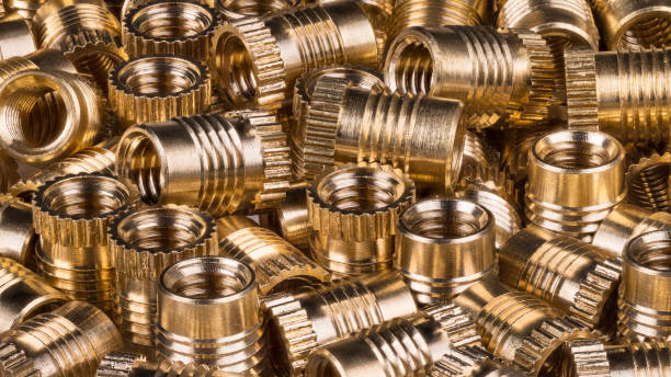 istock Glossy bronze threaded bushings as background. Full depth of field 1000929372