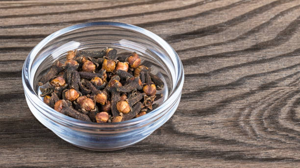 Close-up of spicy aromatic cloves in glass. Syzygium aromaticum. Great depth of field stock photo