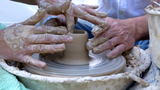 Potter's Hands Work with Clay on a Potter's Wheel