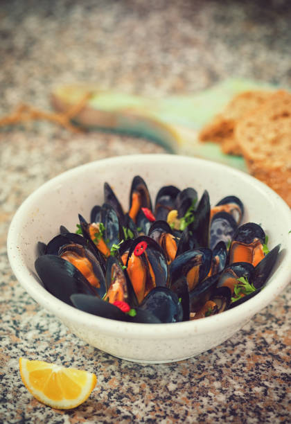 Freshly steamed blue mussels dish with white wine,chili pepper and parsley