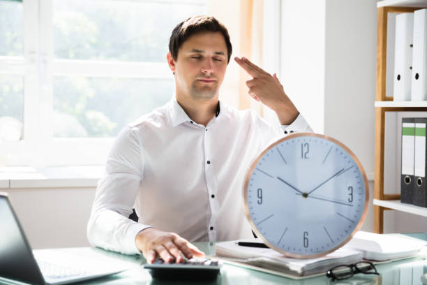 istock Tired businessman making shooting gesture 1000963806
