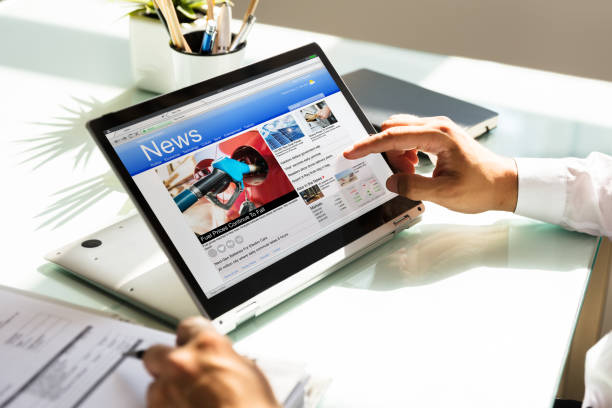 istock Businessman checking online news on laptop 1000963864