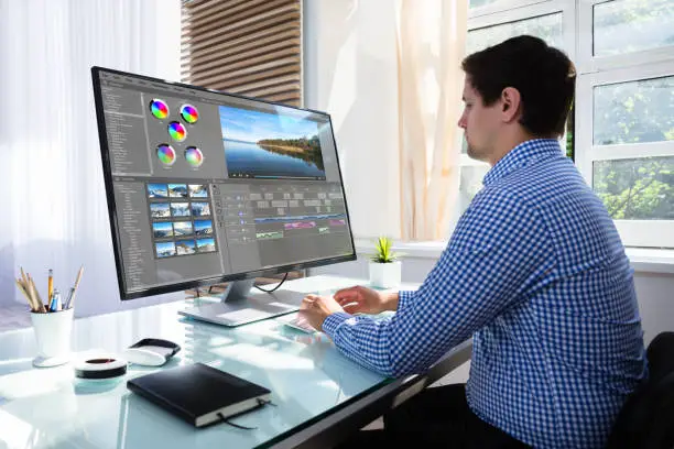 Photo of Editor editing video on computer