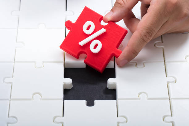 istock Man's hand connecting red piece into jigsaw puzzle 1000964526
