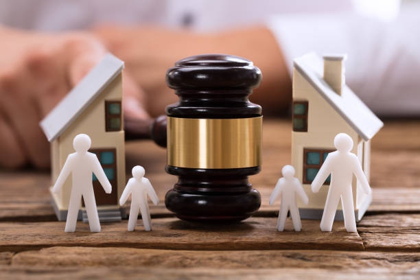 Close-up of mallet showing separation of family and house Close-up of mallet showing separation of family and house on wooden desk family conflicts stock pictures, royalty-free photos & images