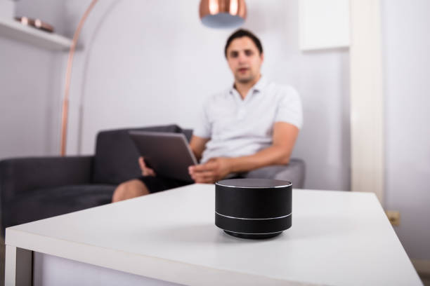 istock Man listening to music on wireless speaker 1000968854