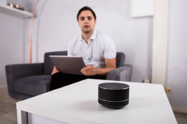 istock Man listening to music on wireless speaker 1000969140