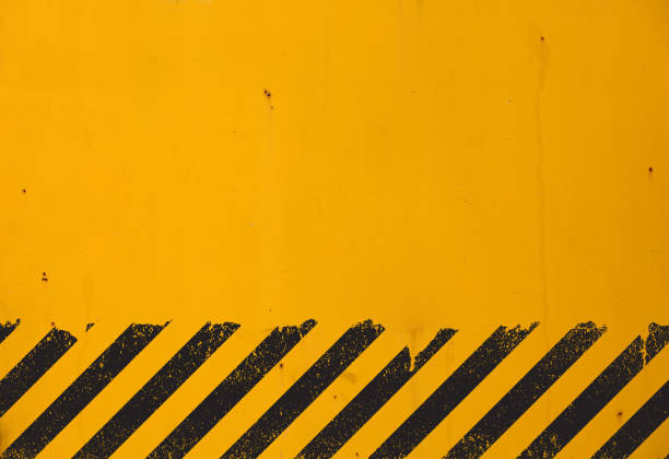istock Yellow background with black grunge hazard sign 1000973368