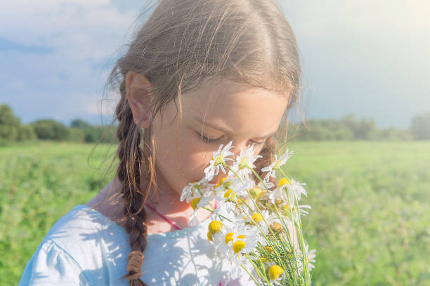 istock Girl with meadow flowers. 1000976512