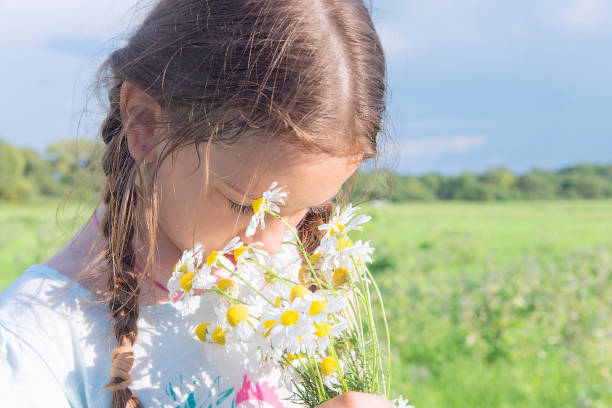 istock Girl with meadow flowers. 1000976538